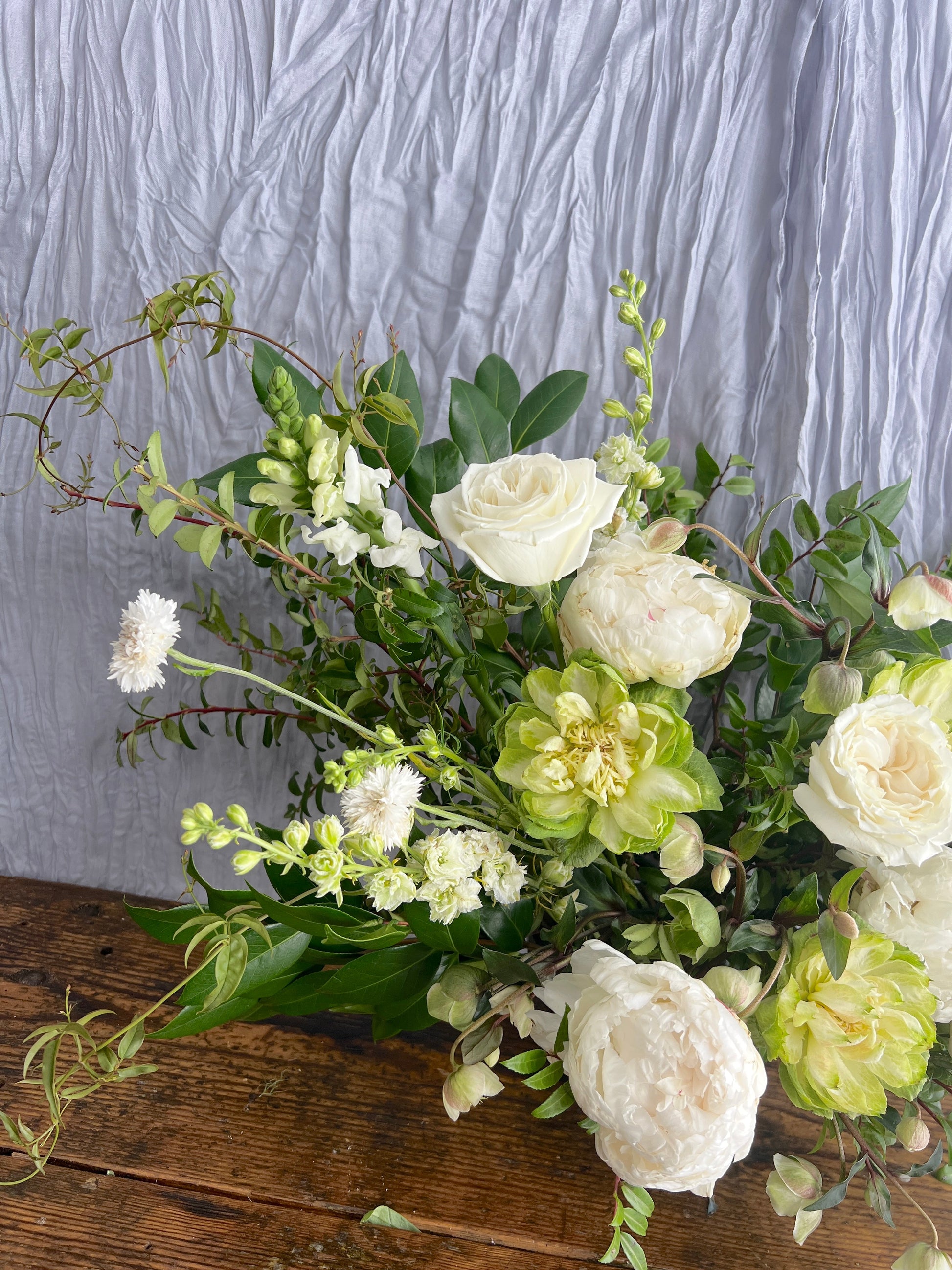 Ceremony arrangement with roses and vines Sweet Blossoms LLC
