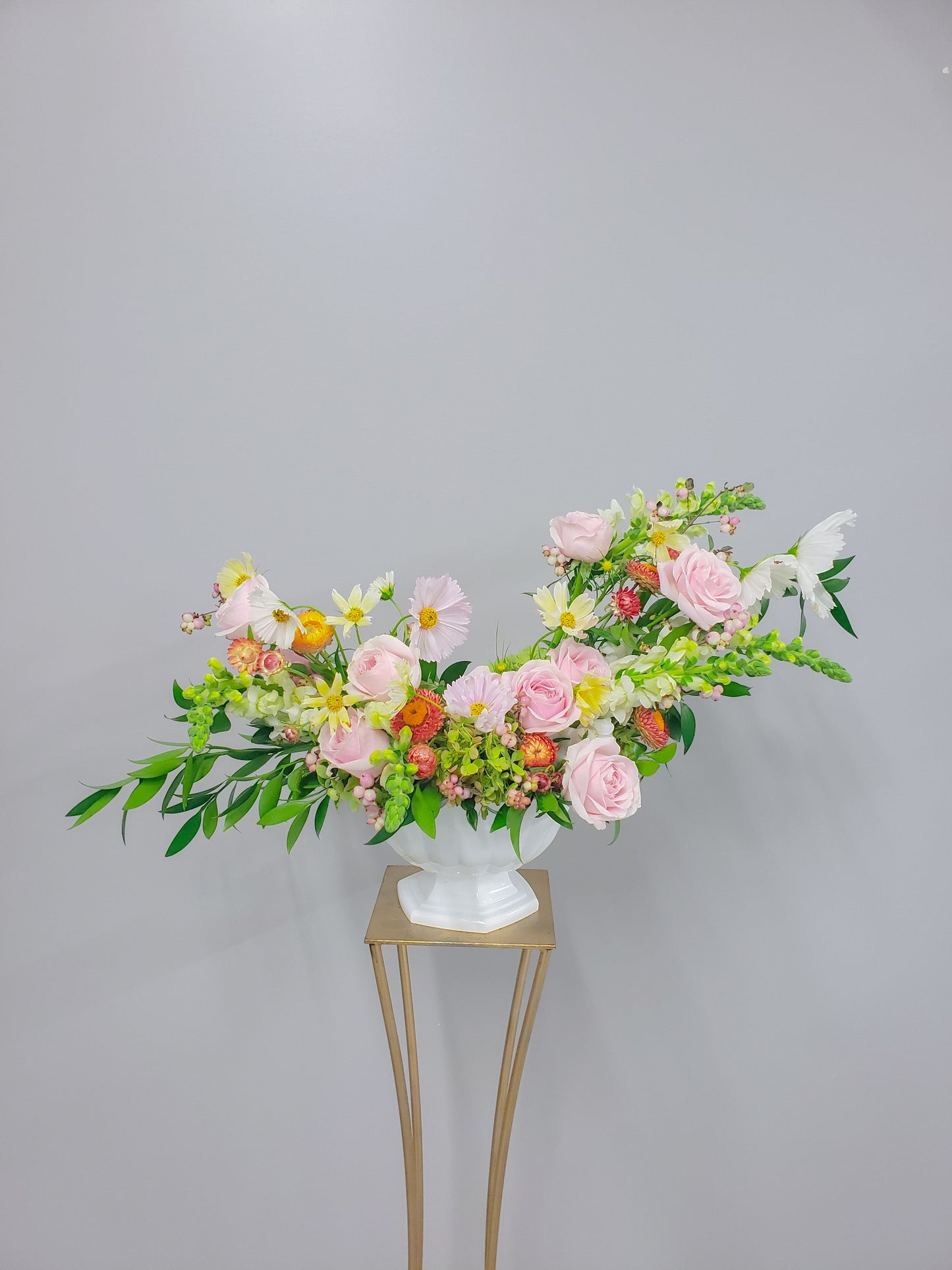 pink and citrus Ceremony arrangement on gold stand Sweet Blossoms LLC