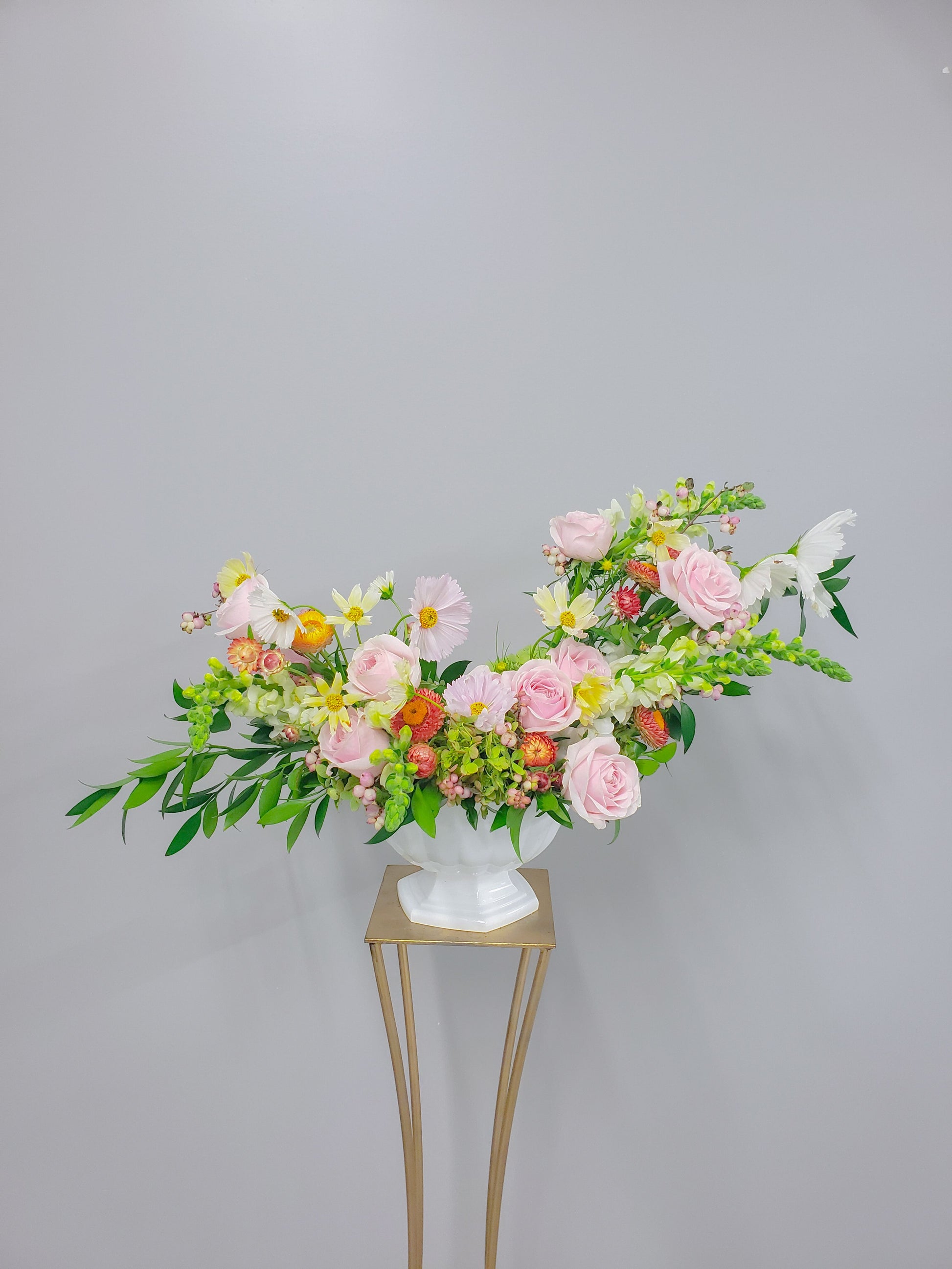 pink and citrus Ceremony arrangement on gold stand Sweet Blossoms LLC