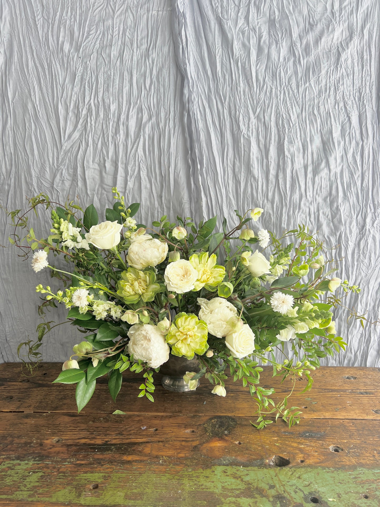 ceremony arrangement with roses and greenery Sweet Blossoms LLC